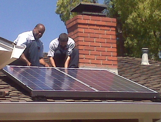 Valley Heating technicians installing solar panels on a residential rooftop