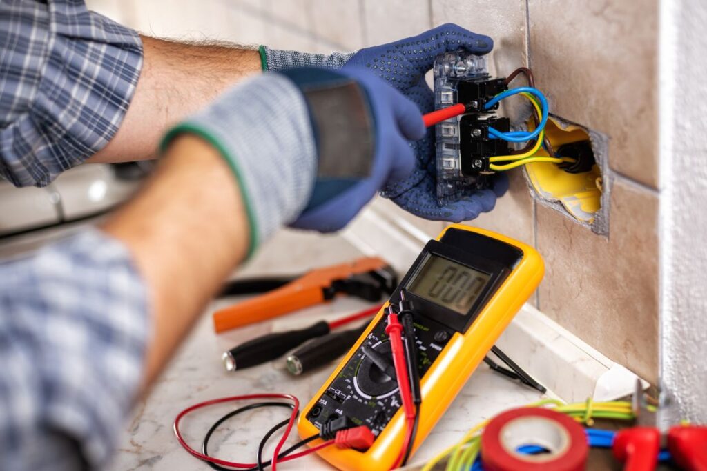 Electrician at work with safety equipment on a residential electrical system. Electricity.